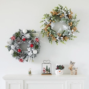 Christmas wreath set with Santa, snowman and reindeer ornaments on a white fireplace