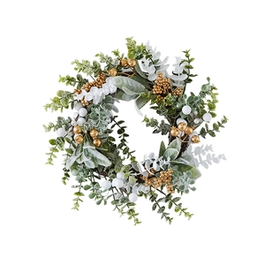 Christmas wreath with green leaves, white and gold berries on natural rattan base