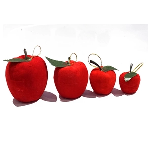 Four red flocked apple-shaped gift boxes in different sizes for Christmas decoration