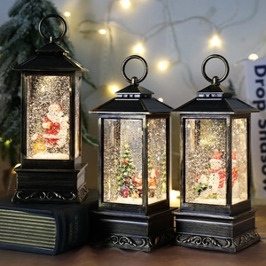Vintage bronze Christmas lantern with glitter snow globe and festive figurines