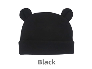 Close-up of black knitted baby hat with cute bear ears and a folded brim on white background