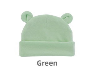 Detailed close-up of light green knitted baby beanie with cute 3D bear ear decorations