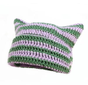 Detail of handmade purple and green striped knit cat ear hat with crochet texture