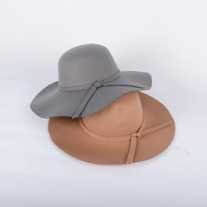 Detail view of grey and camel felt wide brim hats with elegant bow decoration