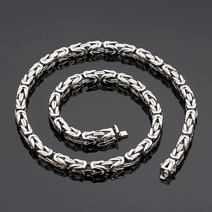 Detailed view of silver Byzantine square chain necklace with clasp on black background