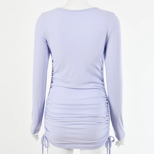 Back view of a purple long sleeve mini dress featuring ribbed texture and side drawstrings