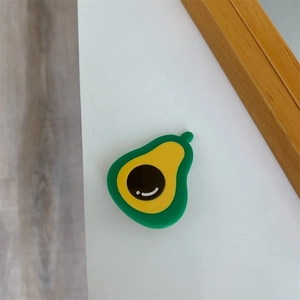 Close-up of a small avocado shaped acetate hair clip in green and yellow finish