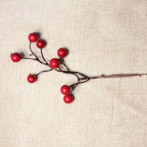 Artificial red berry branches with 8 stems on rustic burlap for Christmas home decoration
