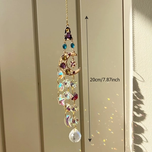 Golden moon suncatcher with purple and blue crystals showing rainbow light refraction
