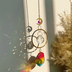Golden moon suncatcher with raw amethyst and crystal ball reflecting rainbow light