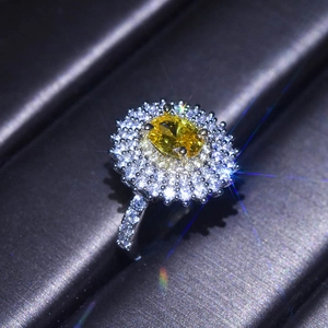 Luxurious oval yellow moissanite ring with double halo setting on a silver band