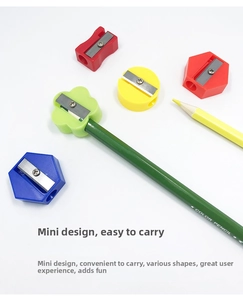Close-up of mini manual pencil sharpeners in various geometric shapes and bright colors