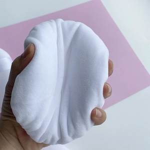 Detailed macro view showing the soft velvet texture of the white round powder puff