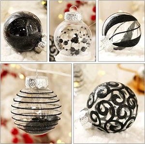 Detailed view of clear 6cm Christmas ornaments with black feathers and glitter patterns