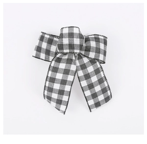 Close-up of black and white checkered ribbon bow for Christmas tree decoration