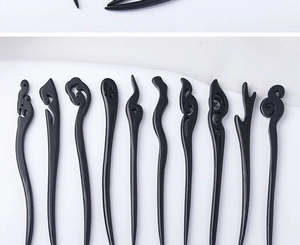Detailed view of assorted black wood hairpins with traditional cloud and antler carvings