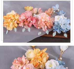 Detail of handmade silk flower hair clips with elegant pearl tassels and floral petals