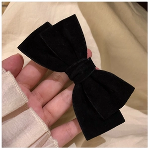 Close-up of black velvet bow hair tie showcasing the soft texture and French vintage style