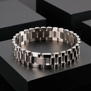 Men's punk style brushed silver stainless steel watch-link bracelet on a display stand