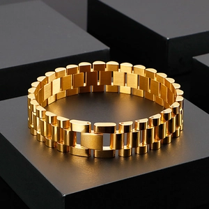 Detail of 15mm gold-plated stainless steel watch strap style bracelet on black stand