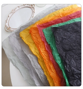 Detailed view of colorful wrinkled tissue paper stack for bouquet and gift packaging