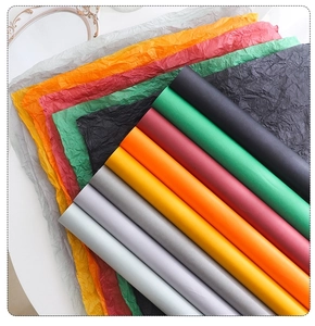 Close-up of colorful wrinkled tissue paper and smooth rolls for floral bouquet packaging