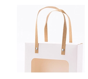 Detail of white gift bag with transparent window, metal rivets and flat paper handles