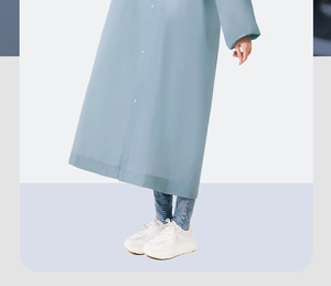 Detail of light blue waterproof EVA raincoat hem with stylish white platform sneakers