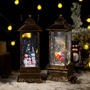 Vintage bronze Christmas lantern with Santa and Snowmen figures featuring swirling snow