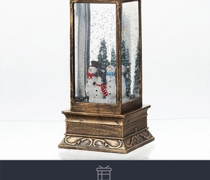 Detail of vintage bronze Christmas snow globe lamp with snowman family and swirling snow