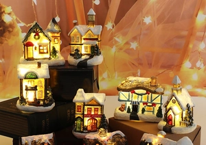 Group view of LED lighted Christmas resin houses with snow textures and holiday glow