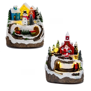 Detail of LED glowing resin Christmas house with snowman and Santa on snow-covered rock base