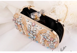 Detail view of gold crystal clutch bag with colorful bead embroidery and chain strap
