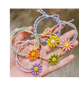 Close-up of colorful daisy elastic hair ties in mint green, purple, and pastel shades