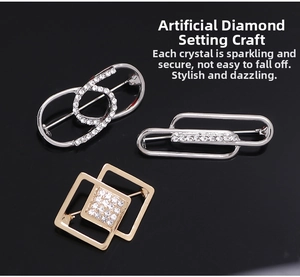 Detailed view of silver and gold brooch pins with luxury pavé crystals and geometric design