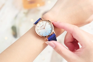 Elegant close-up view of a gradient floral ladies watch with a blue magnetic mesh strap