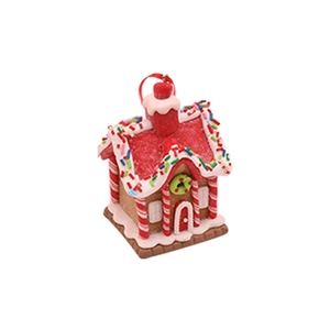 Detail of Christmas gingerbread house ornament with red glitter roof and candy cane pillars