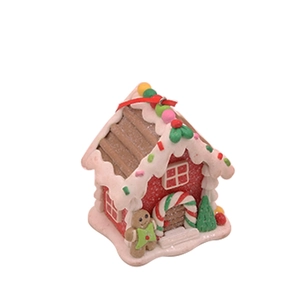 Detailed view of polymer clay Christmas gingerbread house with white icing and candy accents