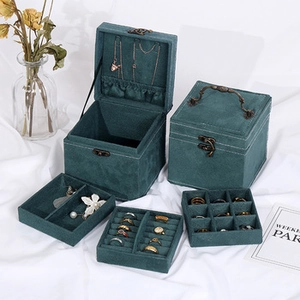 Detail view of emerald green velvet jewelry box with multi-layer storage compartments