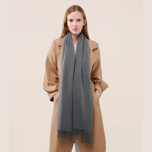 Classic grey cashmere wool scarf with tassels paired with a beige long coat for winter