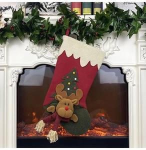 Detail of Christmas stocking with 3D reindeer doll and tree applique by a cozy fireplace