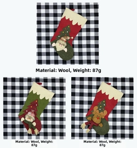 Detailed close-up of wool Christmas stockings with Santa, snowman and reindeer 3D dolls