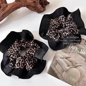 Double-layered leopard print scrunchie set with black pleated trim for elegant hairstyles