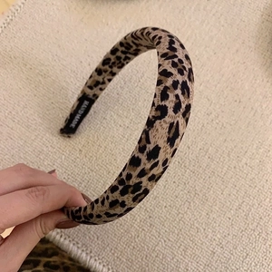 Detailed view of handmade leopard print headband with inner handmade fabric label
