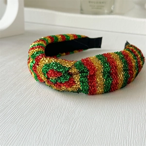 Detailed view of festive knot headband featuring red green and gold glitter stripes