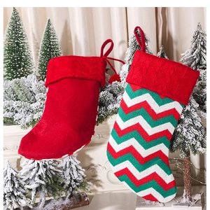Detail of red and wavy knit Christmas stockings hanging by a festive fireplace