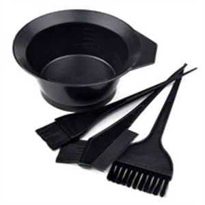 Macro view of a professional hair dyeing kit with a scaled mixing bowl and black brushes