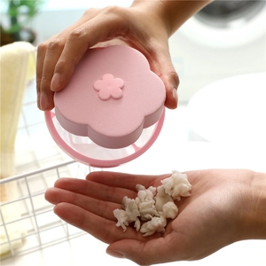 Pink floating hair filter for washing machines collecting laundry lint and debris