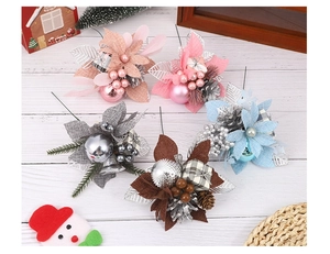 Close-up of assorted Christmas picks with pine cones, berries, and fabric flowers