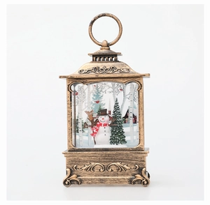 Detail of bronze Christmas lantern featuring snowmen, trees and intricate relief base